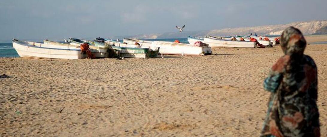 Somali women looking out at boats 