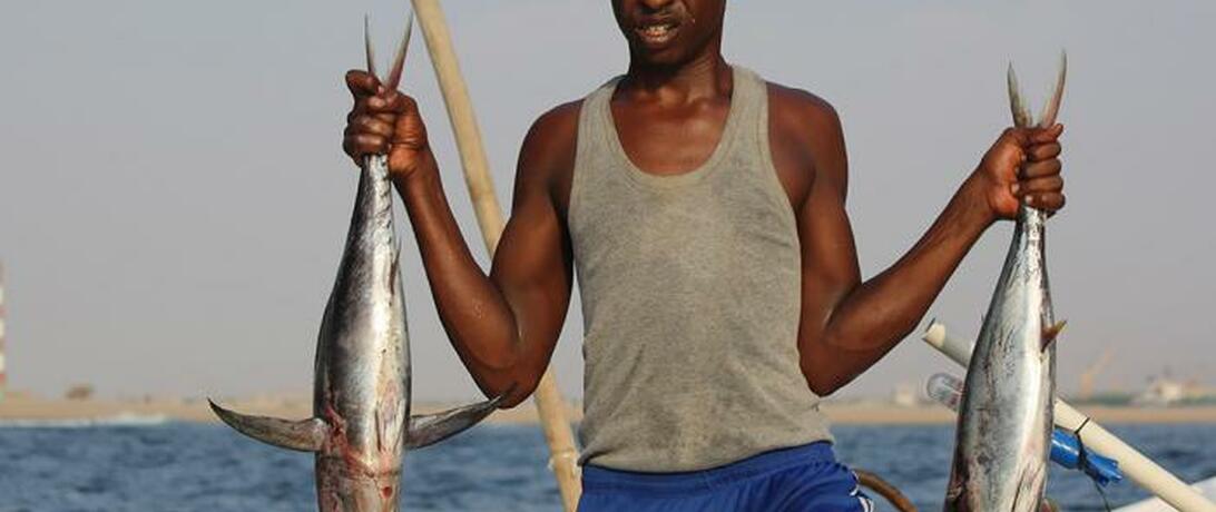 Somali man holding two fish