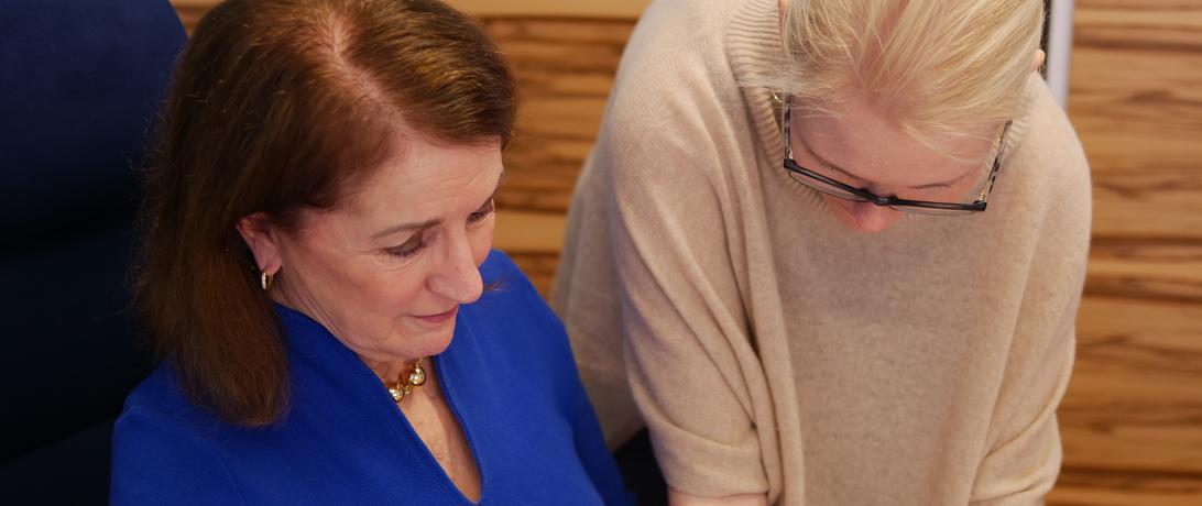 Laura Rockwood and Veronika Bedenko looking over a document