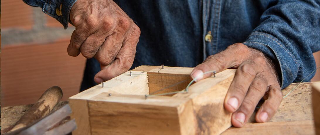 Hands building a beekeeping box, Saravena, Arauca.