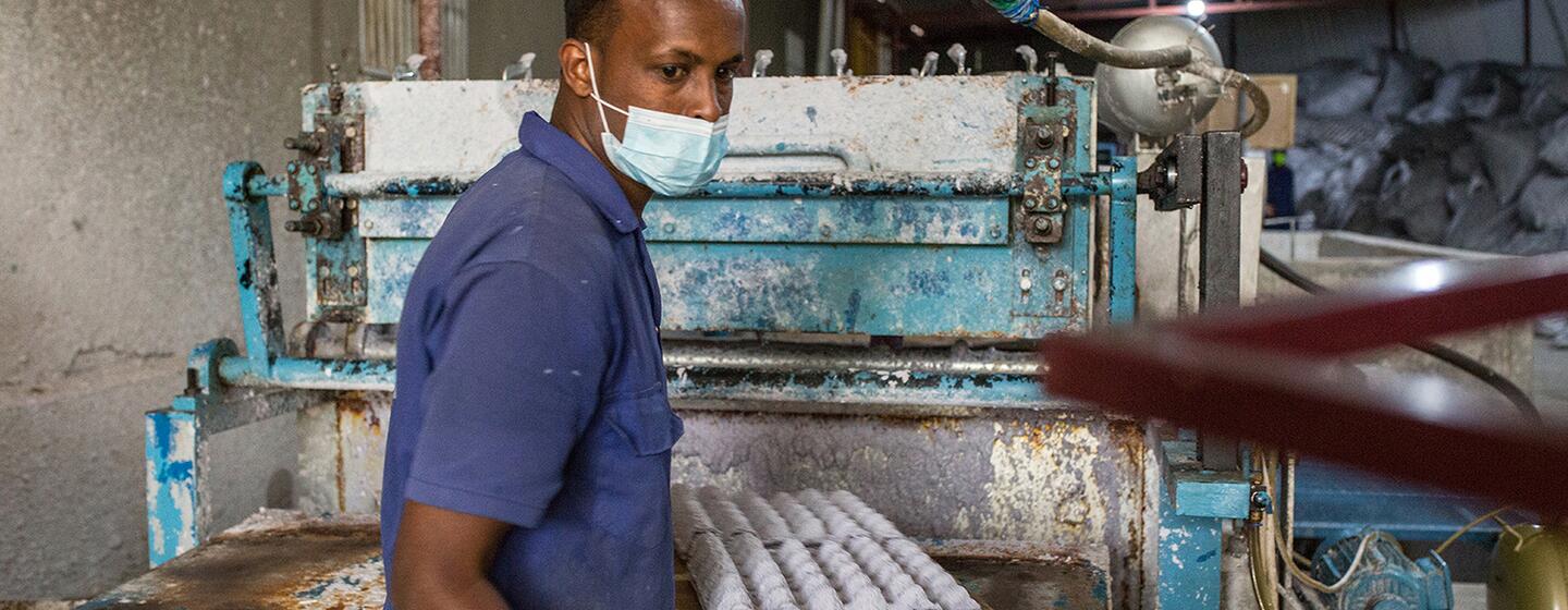 Man in mask with empty egg cartons